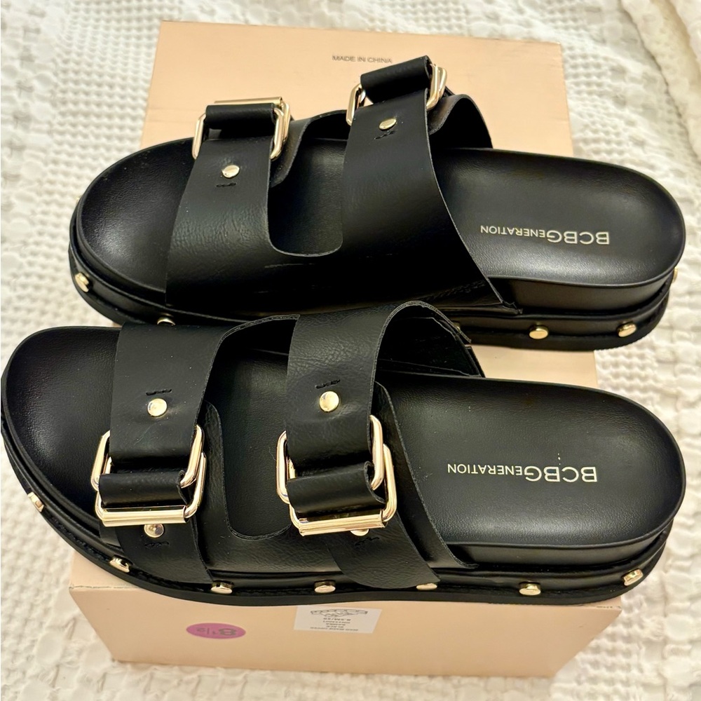 BCBGeneration Black Sandals with Gold Accents